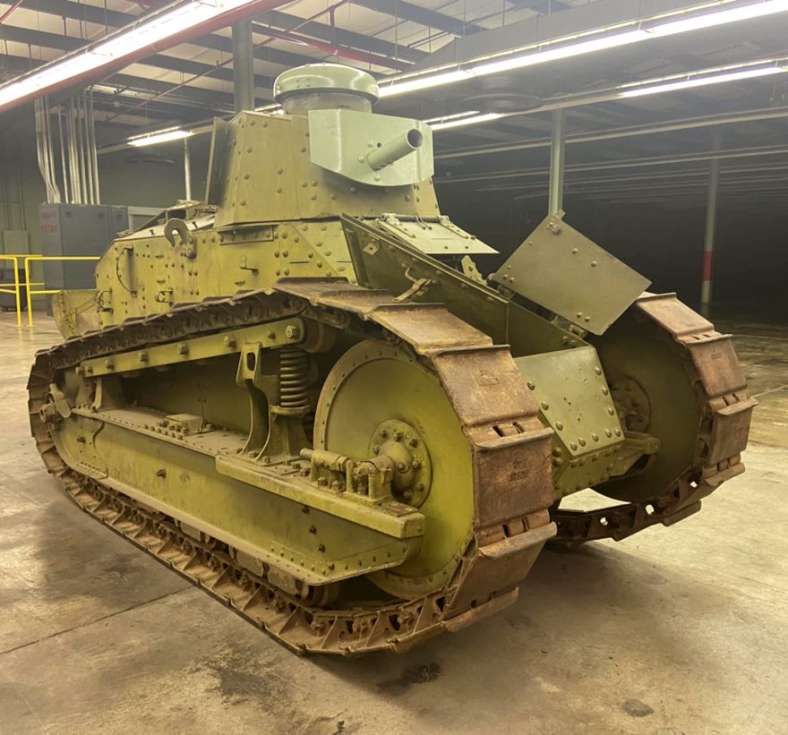 The same Renault M1917 today, unrestored, standing on a workshop floor with rusted track links and bare rivets.